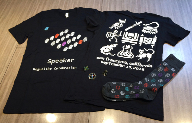 Speaker t-shirt, attendee t-shirt, and socks on a table